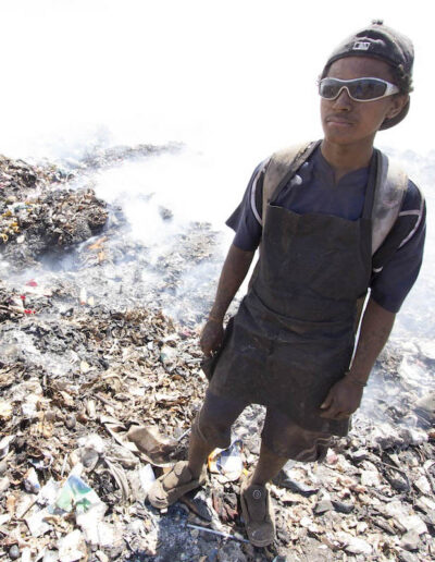 Young man in the trash dump