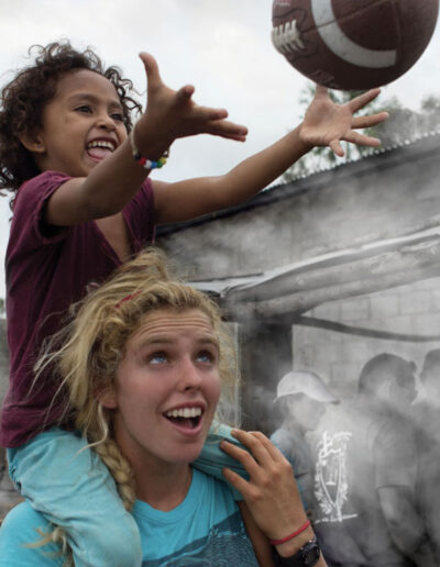 Sponsor with young girl on her shoulders