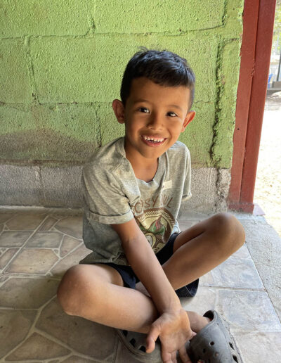 Smiling boy sitting on the ground